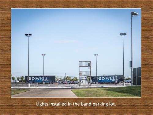 Photo of lights being installed in the band parking lot.