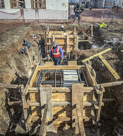 construction photo of piers at front entrance